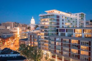 A drone view of the Ovation 309 building and the Madison, WI state capitol building