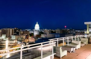A drone view of the Ovation 309 building and the Madison, WI state capitol building
