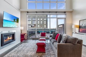 A living room with double high ceilings in an apartment building on an upper floor
