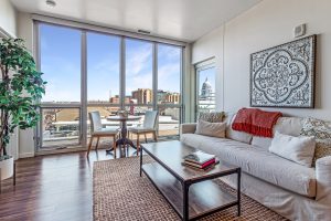 A living room in an apartment building on an upper floor with a view of the Madison, WI capitol through the window