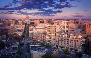 A drone view of the Ovation 309 building and the Madison, WI state capitol building