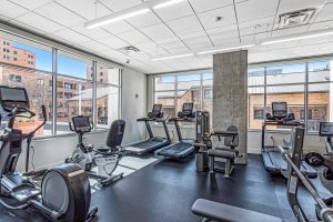 A gym with treadmills, stair steppers, and exercise bikes