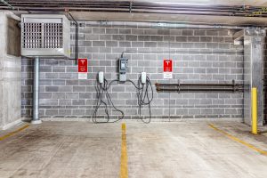 A Tesla charging station in a parking garage